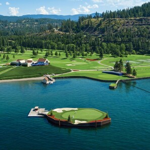 A golf course with a water body, a dock, and a clubhouse. - Guest Favorite, Peaceful, Walkable to Dinning & Shopping. 5-Star clean! (Coeur d'Alene)