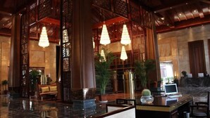 A lobby with a reception desk, seating area, and decorative lighting. - Helan Mountain Forest Park Visitor Service Center (Alxa Left Banner)