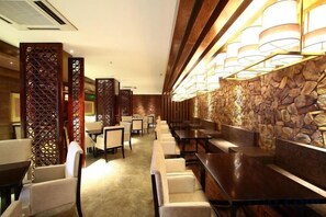 A hotel lobby with a bar area, seating arrangements, and decorative elements. - Helan Mountain Forest Park Visitor Service Center (Alxa Left Banner)