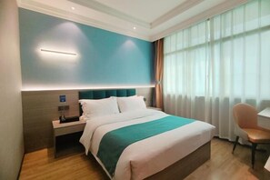 A hotel room with a bed, bedside table, and a chair. - Fuji Hotel Select (Xingwen shop) (Xingwen)