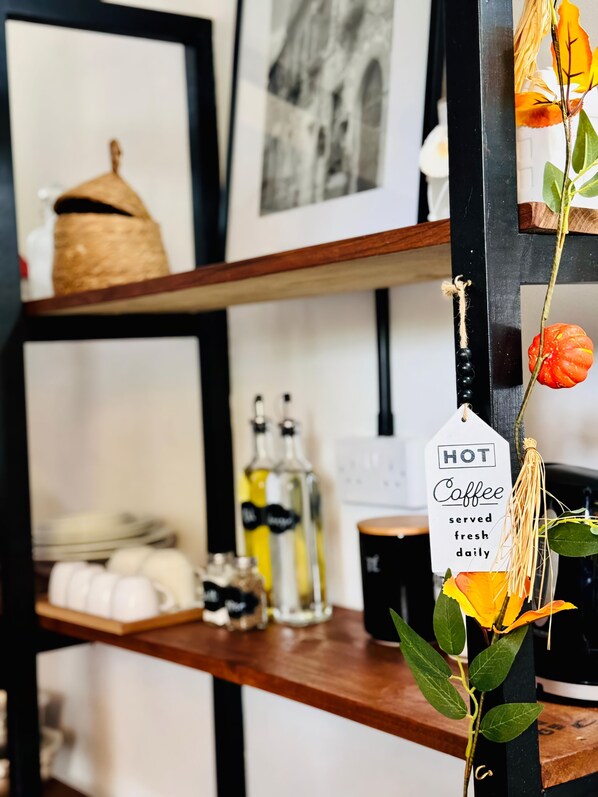 A kitchen counter with a coffee tag, a bottle of olive oil, and a coffee maker. - STUDIO VELLAE!!!
Charming, Safe, fully furnished studio near to everything (Gros Islet)