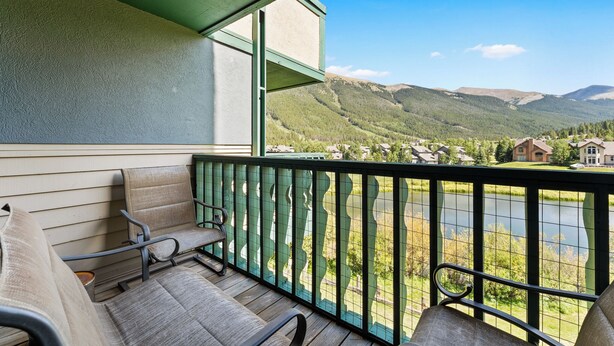 A balcony with two chairs, a view of a lake, and a mountainous landscape. - Gac316c2 (Copper Mountain)
