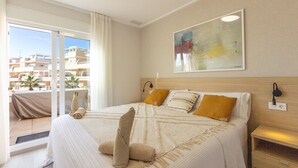 A hotel room with a large bed, a view of the city, and a painting on the wall. - Beautiful home in Torre de la Horadada (Torre de la Horadada)