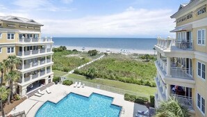 A hotel with a pool and a view of the beach.