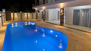 A modern two-story building with a swimming pool.