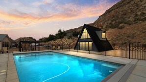 A swimming pool with a modern house and a mountain backdrop. - Hurricane Oasis with Private Pool & Gorgeous Views (Hurricane)