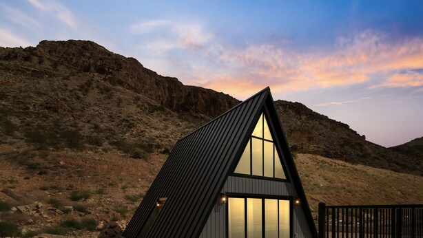 A modern, triangular-shaped building with large windows, set against a mountainous backdrop. - Hurricane Oasis with Private Pool & Gorgeous Views (Hurricane)