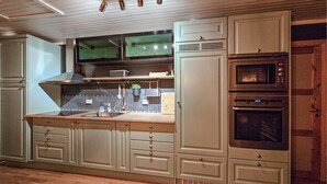 A kitchen with a built-in oven, microwave, and a large window above the sink. - 3 bedroom nice home in Tuddal (Tuddal)