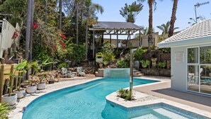 A swimming pool with a wooden deck, surrounded by potted plants and a gazebo. - The Forrester Beachside Retreat Resort Style Pool Oasis (Forresters Beach)
