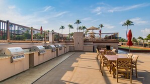 An outdoor patio with a barbecue area, seating, and a pool. - Kaanapali Maui Eldorado K208 Partial Ocean Studio (Lahaina)