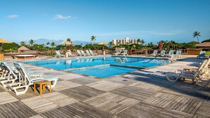 A pool area with multiple lounge chairs and umbrellas, surrounded by a wooden deck. - Kaanapali Maui Eldorado K208 Partial Ocean Studio (Lahaina)