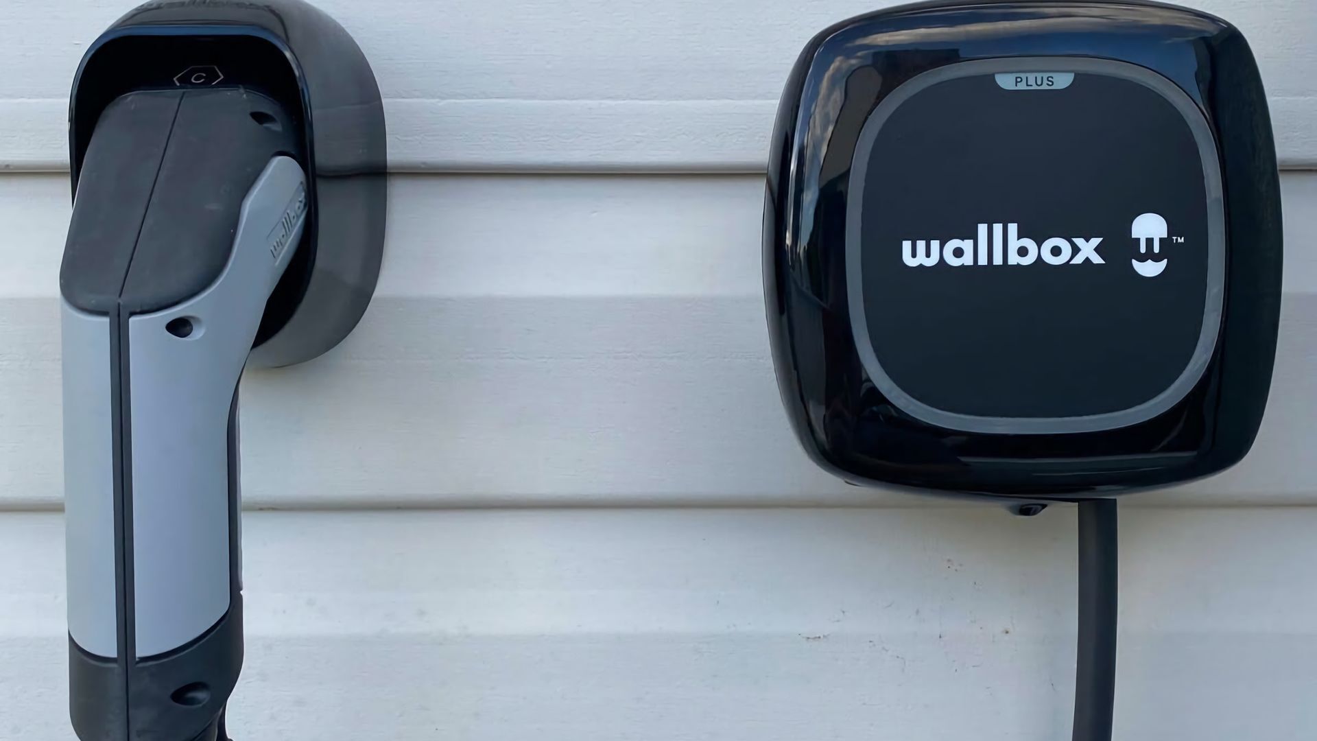 An electric vehicle charging station with a 'wallbox' logo.