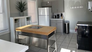 A modern kitchen with a stainless steel refrigerator, a coffee maker, and a sink. - Modern Carriage house 2 blocks from Church Street (Burlington)