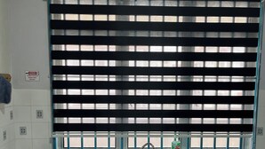 A kitchen with a gas stove, sink, and window blinds. - Homestay WaDi 2, Apartment with pool near beach (Port Dickson Town)
