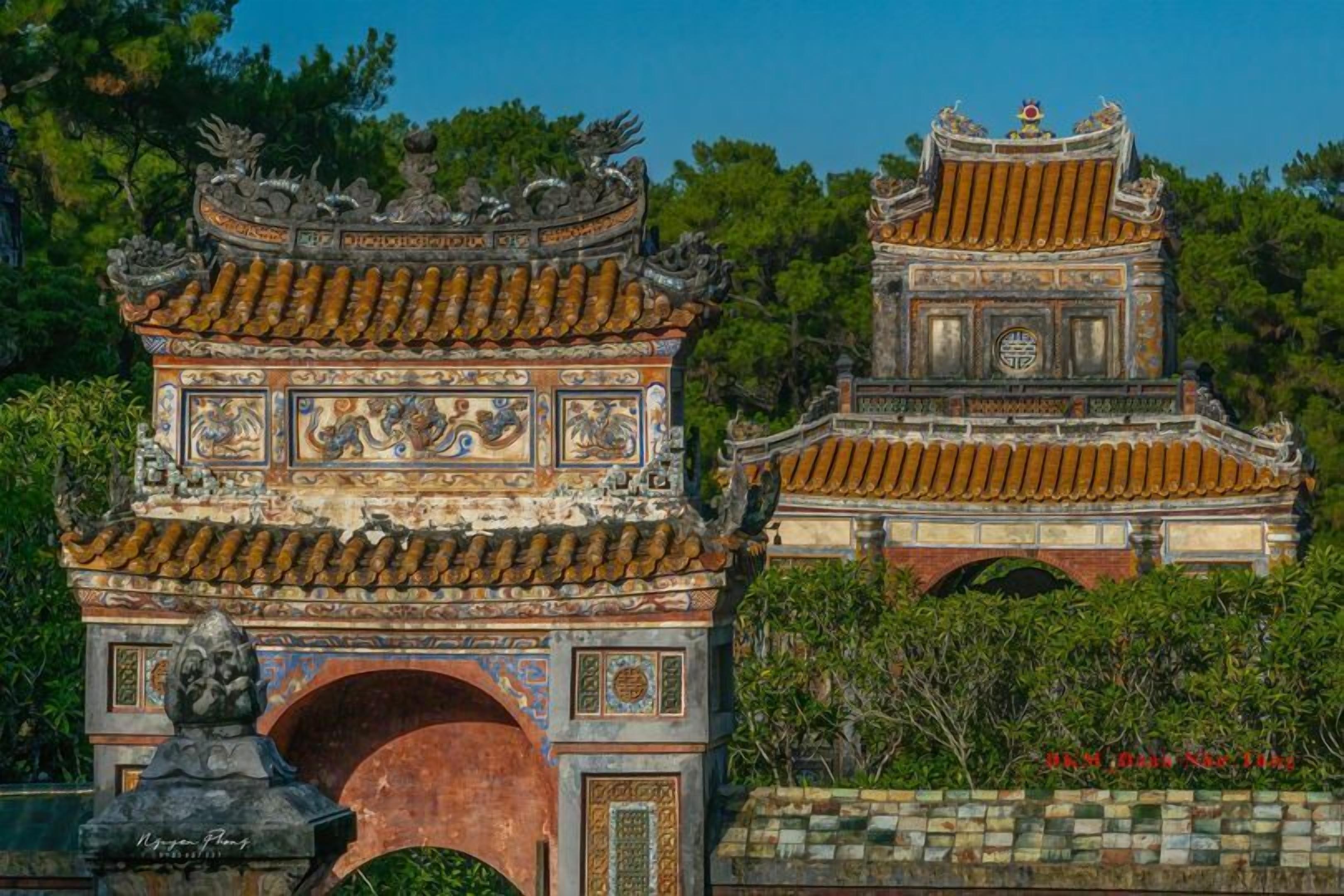 A traditional Chinese gate with intricate carvings and a tiled roof.