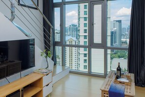 Deluxe Loft, City View | Living area | 40-inch Smart TV with digital channels