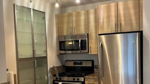 Una cucina moderna con elettrodomestici in acciaio inossidabile, piani di lavoro in granito e forno a microonde integrato.