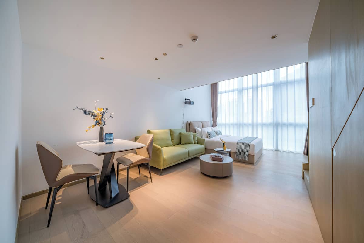 A modern living room with a dining table, a sofa, and a coffee table.