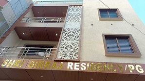 A building with a sign reading "SHRI GIRRAJ RESIDENCY/PG". - Shri Girraj Residency (Mathura)
