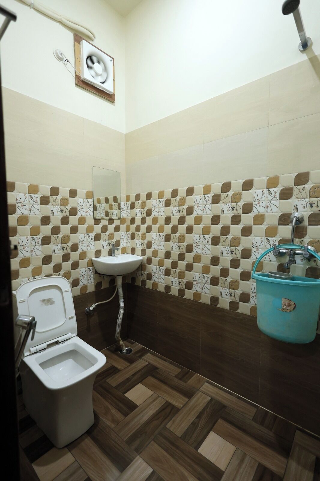A bathroom with a toilet, sink, and shower.