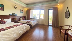 A hotel room with two beds, wooden flooring, a balcony, and a view of the outside. - Misty Hostel Sapa (Sa Pa)