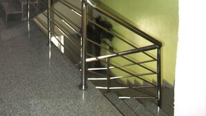 A staircase with metal railings and a handrail, leading to an upper floor. - De Milton Hotel and Suites (Uyo)