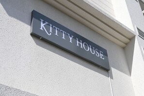A sign that reads "KITTY HOUSE" mounted on a building. - Kitty House (Kolkata)