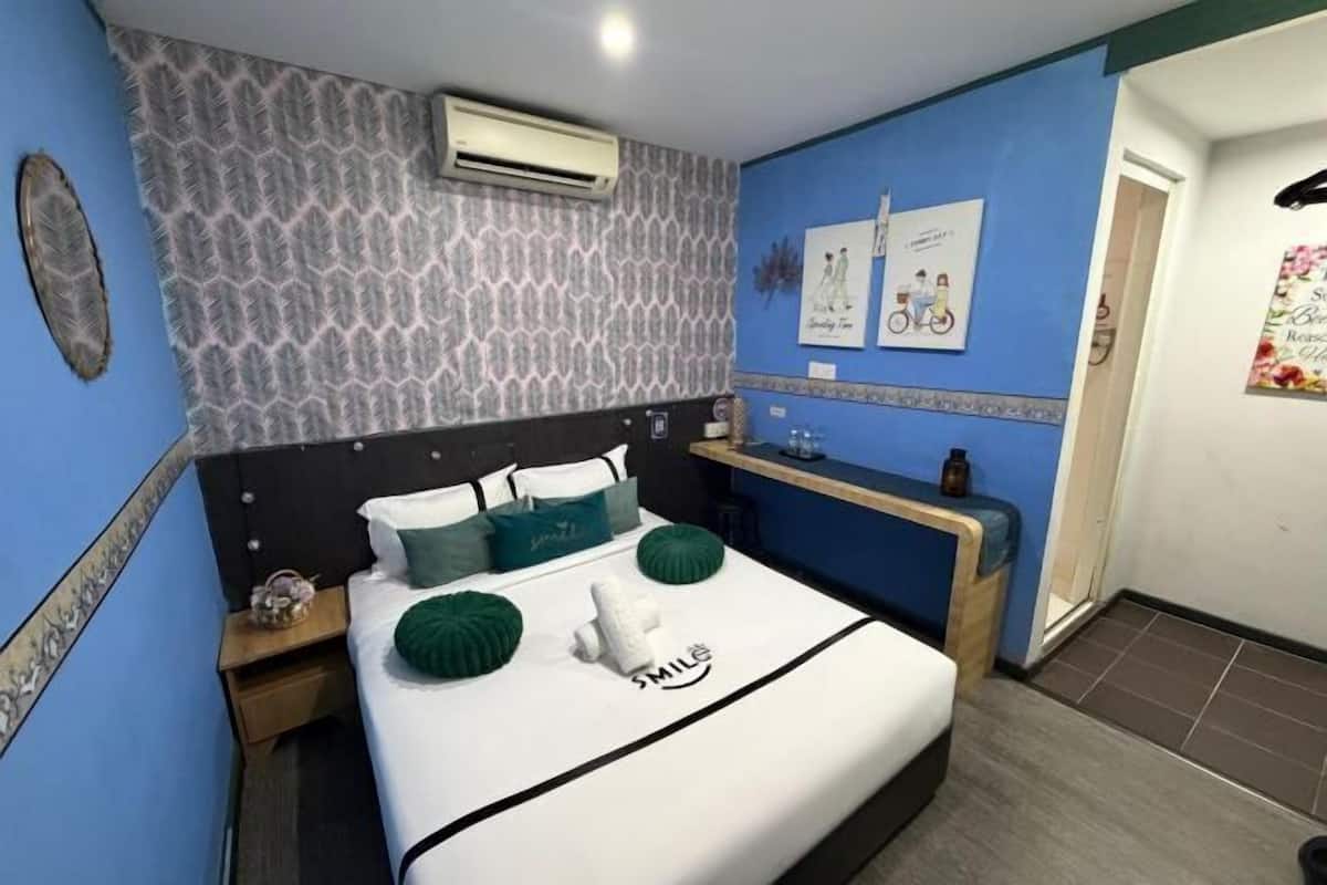 Una camera da letto con un letto, un comodino e decorazioni a parete.