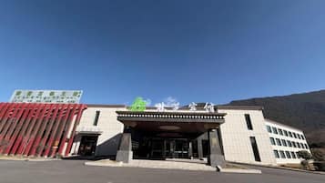 A building with a flat roof, a large entrance, and a sign above the entrance.