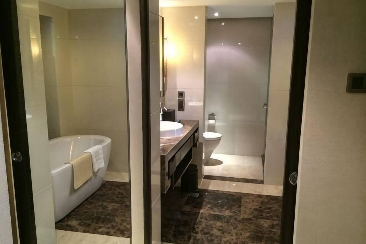A modern bathroom with a bathtub, a sink, and a toilet.