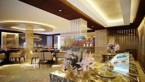 A modern hotel lobby with a marble reception desk, seating area, and a large chandelier. - Grand Metropark Qingdao (Qingdao)