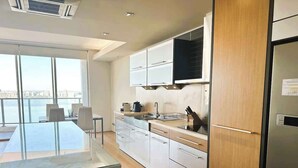 Una cocina moderna con una isla grande, electrodomésticos integrados y vistas a la ciudad.
