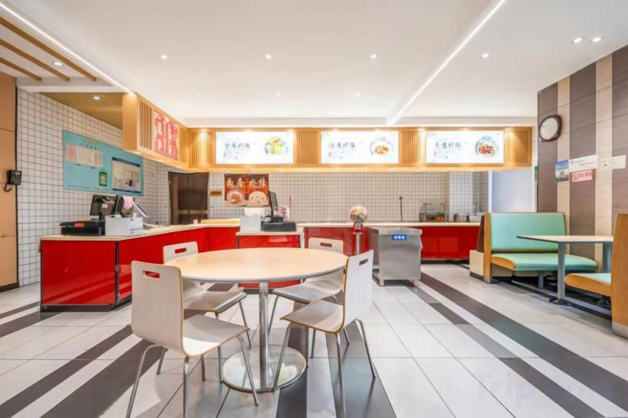 A restaurant with a central island, seating area, and a counter.
