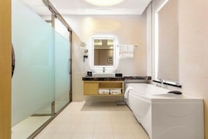 A modern bathroom with a glass shower enclosure, a large bathtub, a vanity with a mirror, and a towel rack. - Baroque Hotel Harbin China Baroque (Harbin)