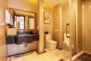A modern bathroom with a marble vanity, a toilet, and a glass shower enclosure. - Yilong International Hotel (Xincai Moon Bay Park) (Xincai)