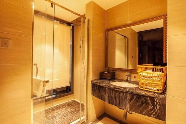 A modern bathroom with a glass shower enclosure, a marble sink, and a large mirror. - Yilong International Hotel (Xincai Moon Bay Park) (Xincai)