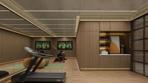 A modern gym with exercise equipment, wooden walls, and a reception area with a plant. - Orange Hotel (Shanghai Caobao Road Sun Moon Light Center) (Shanghai)