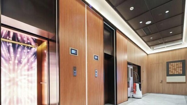 A modern elevator with wooden paneling and digital displays. - Orange Hotel (Shanghai Caobao Road Sun Moon Light Center) (Shanghai)