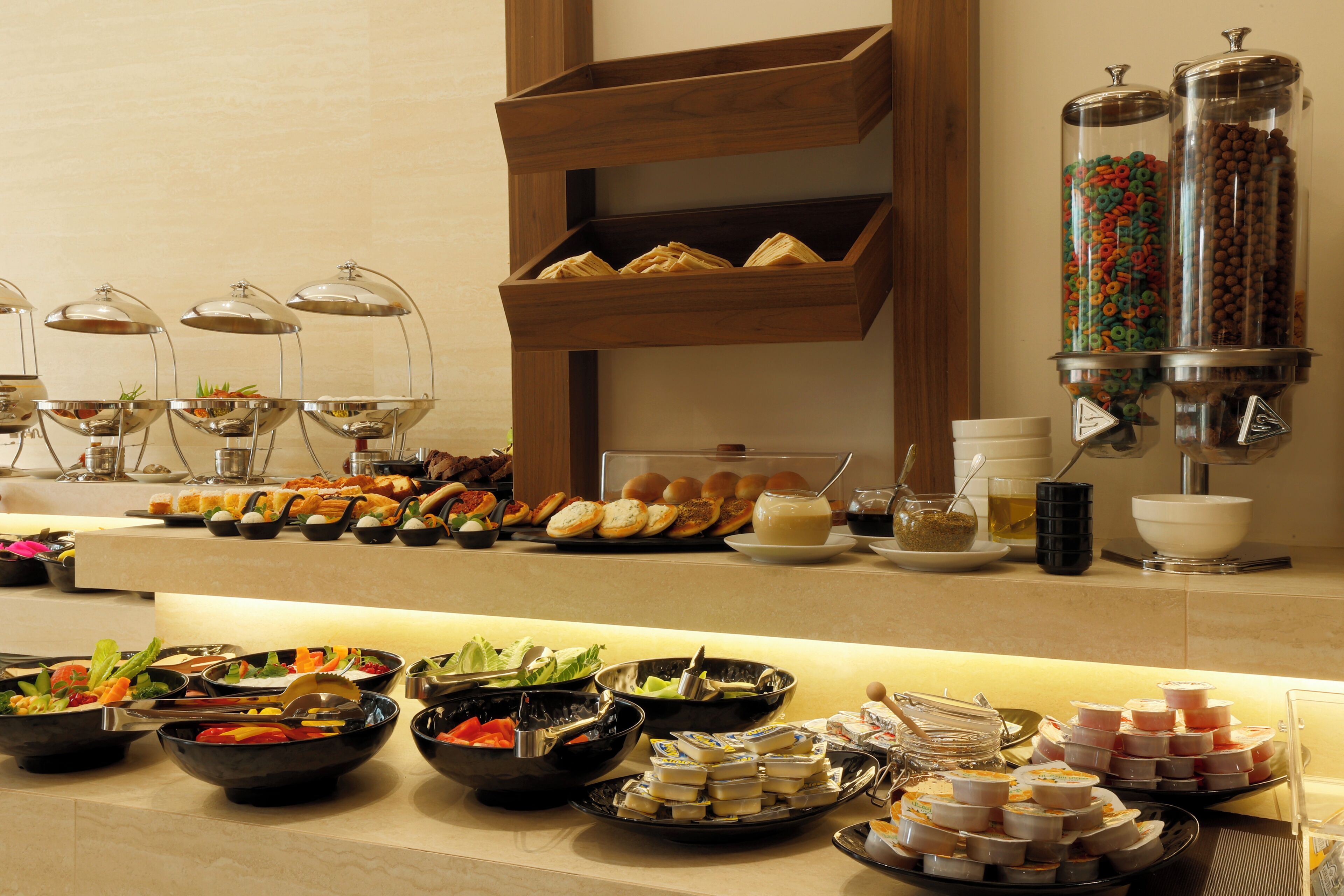 A buffet with various food items and beverages.