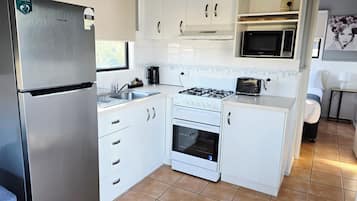 Economy 2 Bedroom Cabin | Private kitchen | Full-size fridge, microwave, stovetop, electric kettle