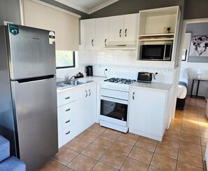Economy 2 Bedroom Cabin | Private kitchen | Full-size fridge, microwave, stovetop, electric kettle - Shellharbour Holiday Village (Barrack Point)