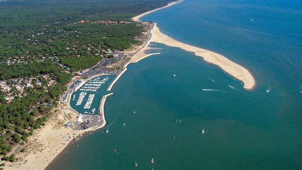 An aerial view of a coastal area with a beach, marina, and residential area. - Cosy apartment for 5 people with WIFI, TV and terrace (La Palmyre)