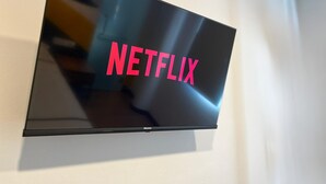 A flat-screen TV mounted on a wall displaying the Netflix logo. - Smile Hotel Cheras Taman Segar (Kuala Lumpur)