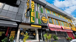 A hotel with a prominent 'HOTEL' sign, a 'PROMOTION' sign, and a large circular sign with 'SMILE' and 'HOTEL' text. - Smile Hotel Cheras Taman Segar (Kuala Lumpur)