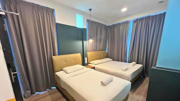 A hotel room with two beds, a wardrobe, and a mirror. - Smile Hotel Subang Airport (Shah Alam)