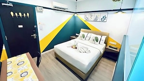 A hotel room with a bed, bedside table, air conditioning unit, and a door. - Smile Hotel Subang Airport (Shah Alam)