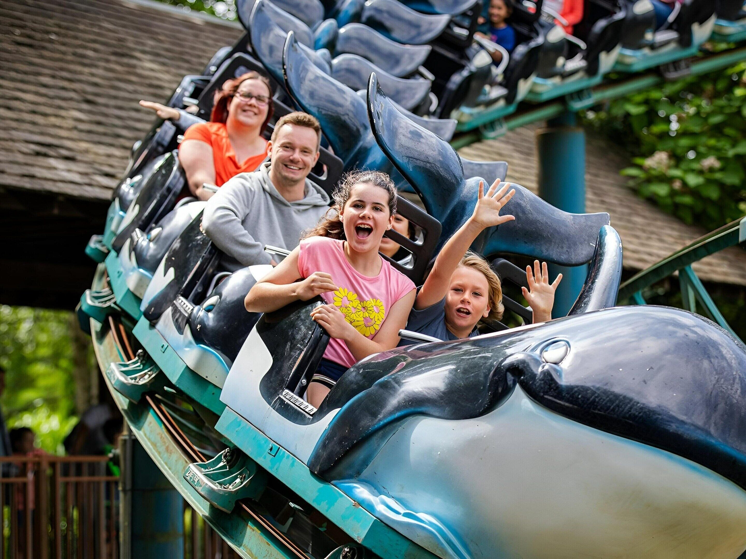 A roller coaster with passengers seated in rows.