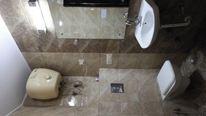 A bathroom with a toilet, bidet, and sink.