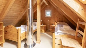 A cozy attic bedroom with two wooden beds, a central heating vent, and a small window. - Traditional Chalet With Terrace (Sankt Georgen am Kreischberg)