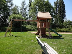 Kids can play on the swing set with a slide and a playhouse.